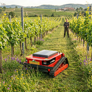 GreenShine GST-900 remote-controlled tracked mower with operator at safe distance